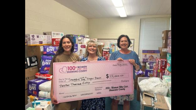 Jade and Elaine receive the check from Wendy Crawford